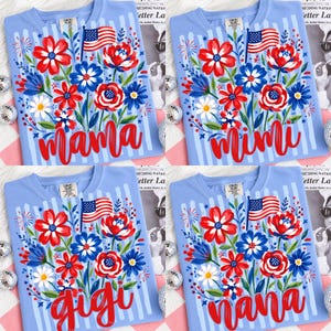 May include: Light blue t-shirts with a floral design in red, white, and blue, featuring an American flag and the words "Mama", "Mimi", "Gigi", and "Nana". The shirts have vertical blue stripes.