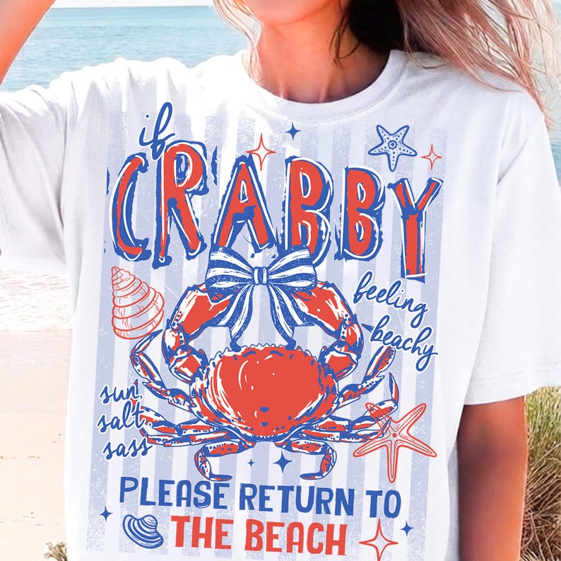 May include: White t-shirt with a red and blue crab graphic and the words "If Crabby Feeling Beachy Please Return to the Beach". The design includes a crab, starfish, and seashell.