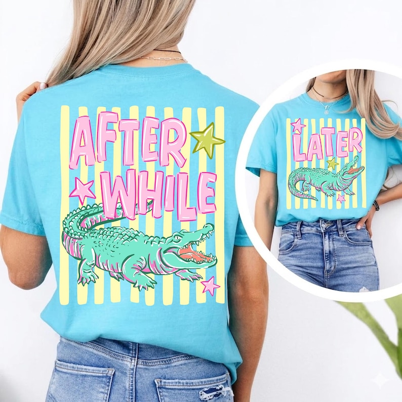 May include: Light blue t-shirts with a graphic of an alligator and the words "AFTER WHILE" and "LATER". The alligator is green with pink accents. The text is pink with yellow and green star accents.