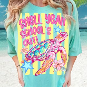 May include: A turquoise t-shirt with a colorful graphic of a sea turtle and the text "SHELL YEAH SCHOOL'S OUT!". The turtle is pink, blue, and orange, with flowers and stars. The background has yellow stripes.