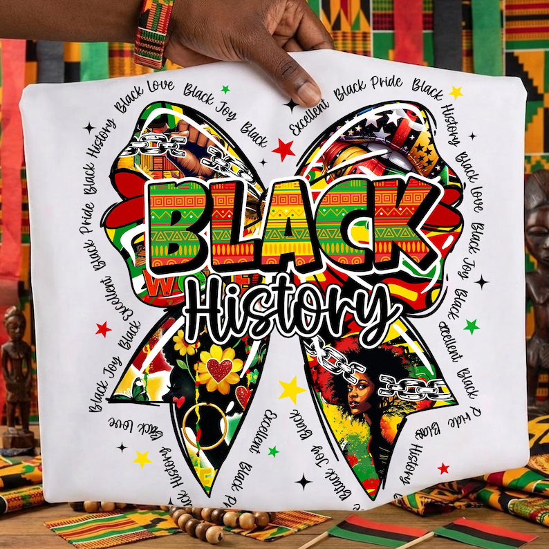 May include: White t-shirt featuring a large bow design with the words "BLACK HISTORY" in bold, colorful letters. The bow is decorated with various patterns, images of a woman, and the phrases "Black Love," "Black Joy," and "Black Pride."