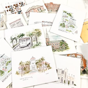 May include: A collection of watercolor illustrations of various landmarks and locations in Georgia, including the state outline, SunTrust Park, Valdosta State University, and a trolley.