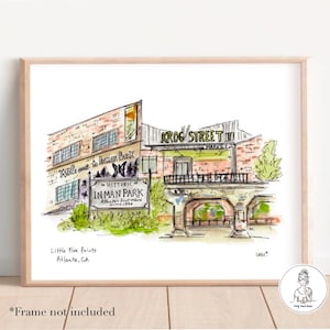 May include: A watercolor illustration of a brick building with a sign that reads "Krog Street Market" and a sign that reads "Welcome to Inman Park, The Historic Atlanta's First Suburb since 1889". The illustration is in a light blue frame and has the text "Little Five Points, Atlanta, GA" at the bottom.