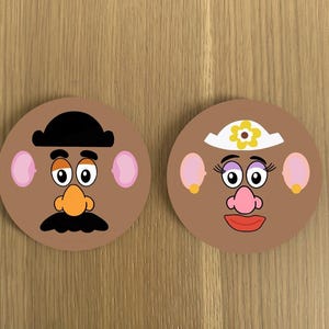 May include: Two round brown coasters featuring cartoon faces of Mr. and Mrs. Potato Head. Mr. Potato Head has a black hat, brown eyebrows, an orange nose, and a black moustache. Mrs. Potato Head has a white headband with a yellow flower, purple eyelashes, and a pink nose.