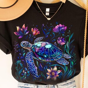 a woman's t - shirt with a turtle on it