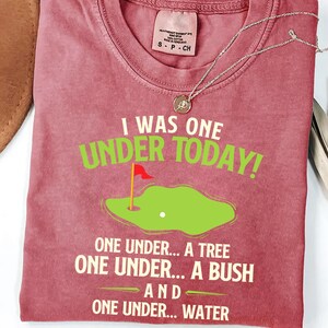 a t - shirt with a picture of a golf course on it