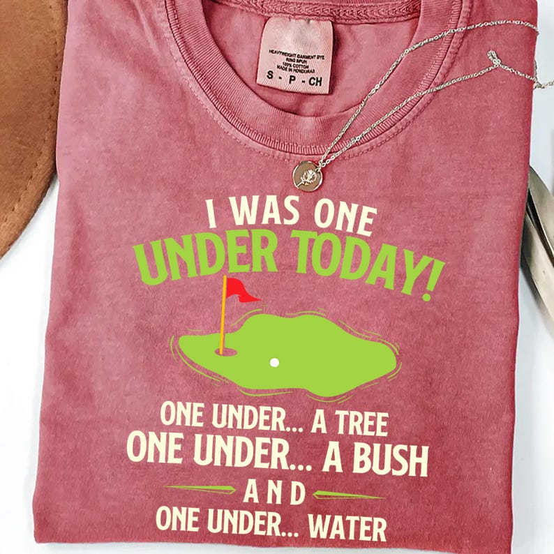 a t - shirt with a picture of a golf course on it