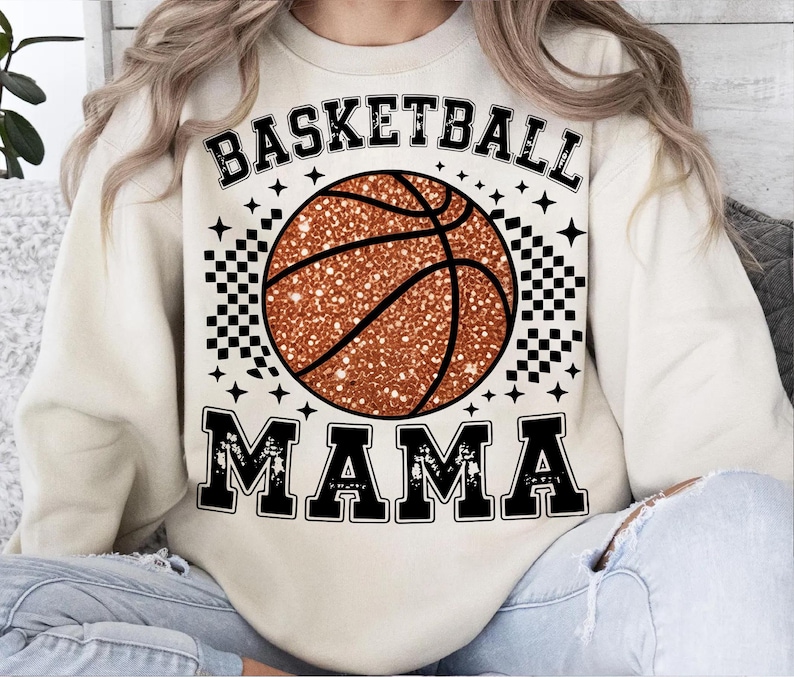 A person wearing a white sweatshirt with a basketball graphic and the text "BASKETBALL MAMA" printed on it.