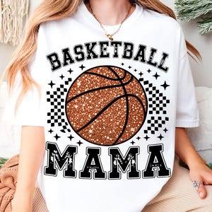 A person wearing a white t-shirt with a basketball graphic and the text "BASKETBALL MAMA" printed on it.