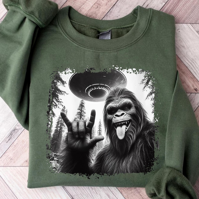 a green shirt with a picture of a gorilla holding a frisbee