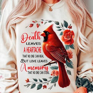 a woman wearing a sweatshirt with a cardinal on it