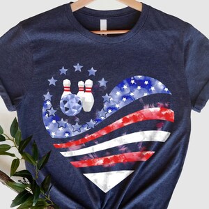 a t - shirt with a bowling ball in the shape of an american flag
