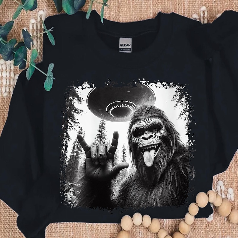 a black and white photo of a gorilla holding a frisbee