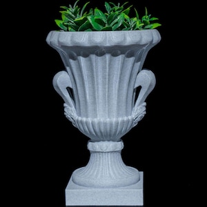 May include: A white ceramic urn with a square base and ornate details. The urn is filled with green leafy plants.