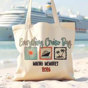 May include: Cream-colored tote bag with the text "Everything Cruise Bag" and three square illustrations: a sun, a cruise ship, and palm trees. Below the illustrations, the text reads "MAKING MEMORIES 2026". The bag has two handles and is on a sandy beach.