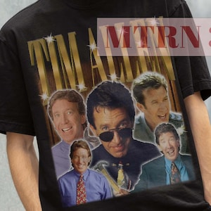 May include: Black t-shirt with a vintage-style graphic of Tim Allen and the text "TIM ALLEN" in gold letters. The graphic features multiple images of Tim Allen in different poses.
