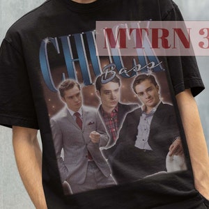 May include: Black t-shirt featuring a graphic print of three men in suits. The text "Chuck Bass" is printed on the shirt.