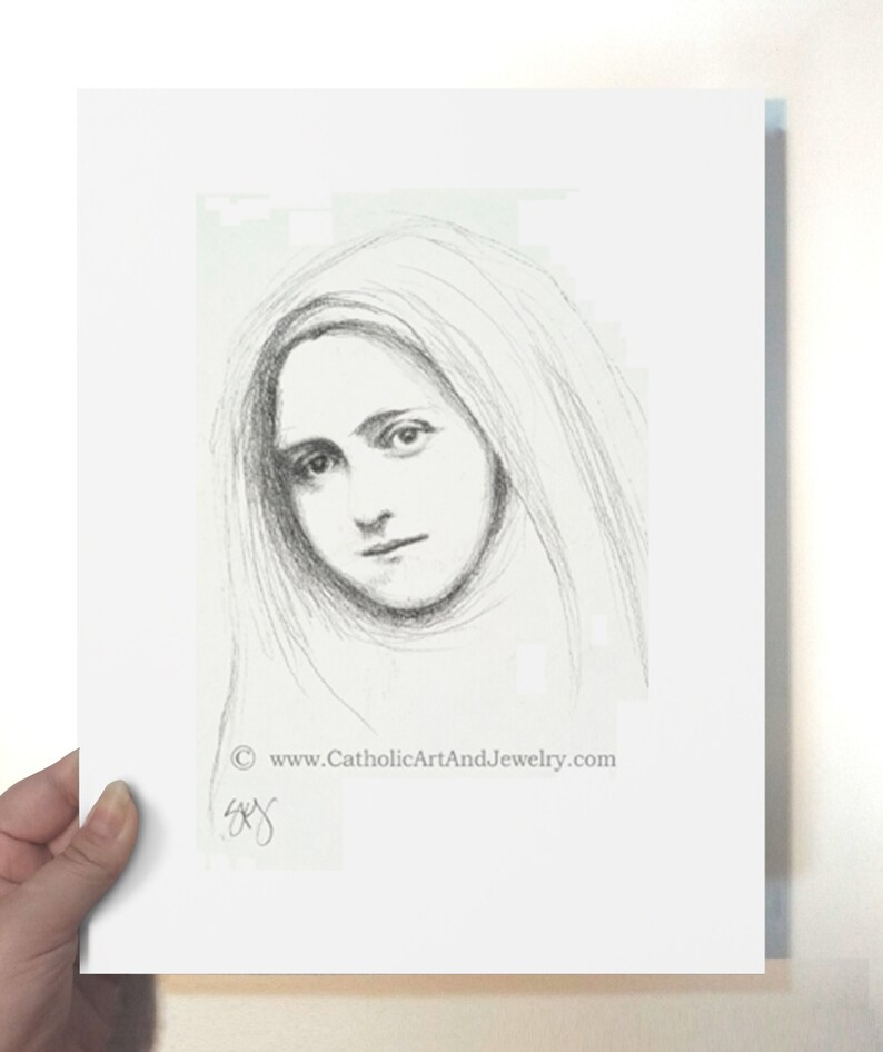 May include: A black and white pencil drawing of a young woman with long hair, wearing a veil. The drawing is signed "SYG" and includes the website "www.CatholicArtAndJewelry.com".