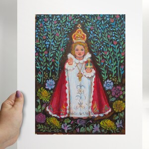 May include: A painting of a young child dressed in white and red robes, wearing a crown and holding a golden orb. The child is surrounded by a garden of flowers and greenery.