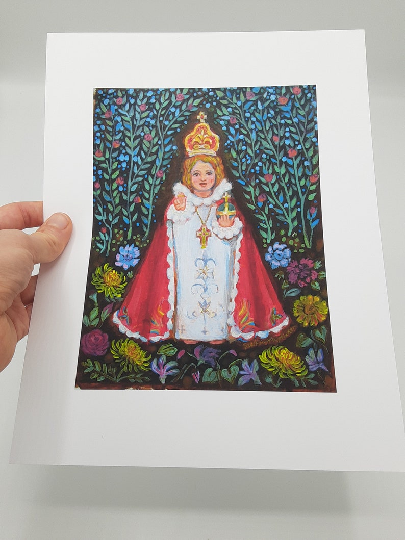 May include: A painting of a young child wearing a red and white robe, a crown, and holding a cross. The child is surrounded by flowers and greenery.