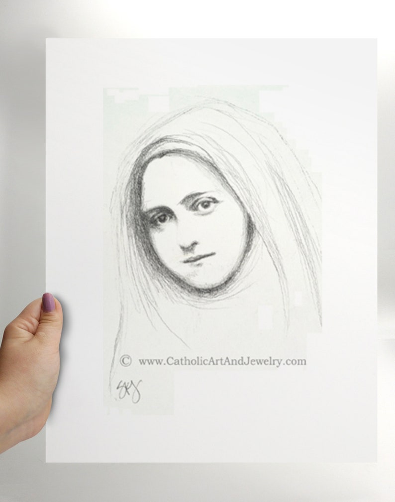 May include: A black and white pencil drawing of a woman's face. The woman is wearing a veil and has a soft expression. The drawing is signed in the bottom right corner with the text "www.CatholicArtAndJewelry.com".