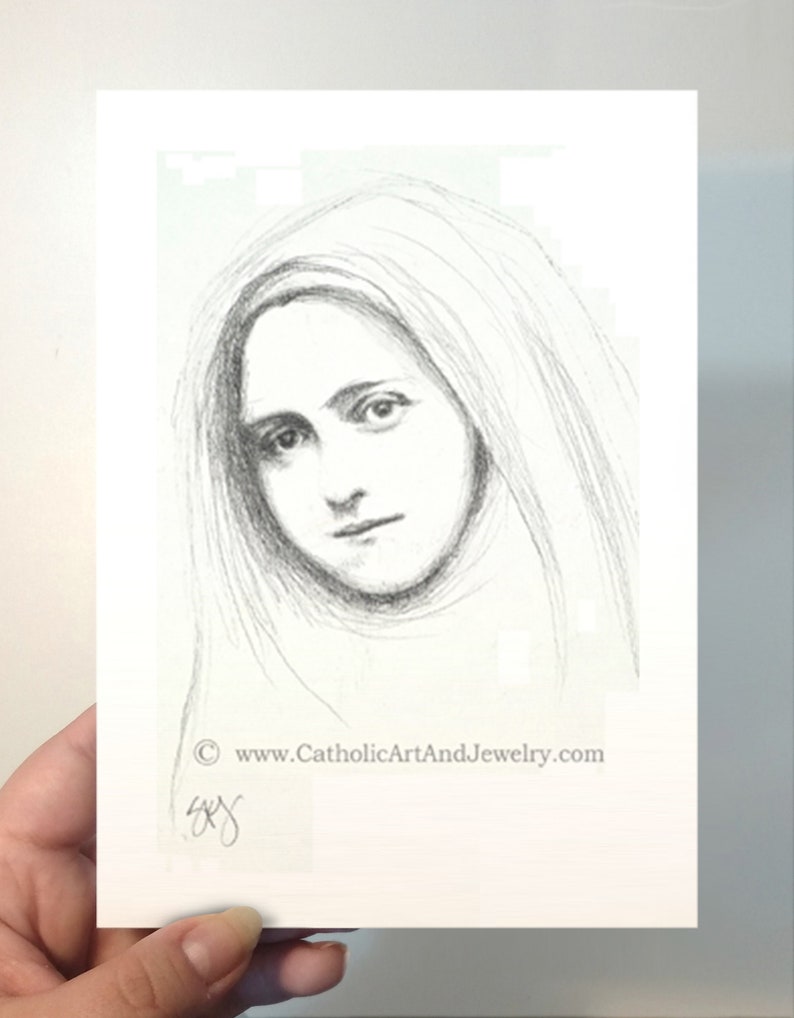 May include: A black and white pencil drawing of a woman with long hair, wearing a veil. The drawing is on a white background with the text "www.CatholicArtAndJewelry.com" at the bottom.