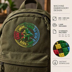 May include: An olive green canvas backpack featuring a circular machine embroidery design with a pixelated figure and the text GAME OVER. The design measures 125 x 125 mm. The graphic includes a rainbow colour gradient and a close-up detail view.