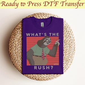 May include: Purple t-shirt with a graphic of a sloth wearing a tie and saying "What's the rush?"