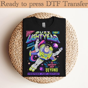 May include: Black t-shirt featuring a colorful graphic of Buzz Lightyear in a space scene. The design includes the text "BUZZ LIGHTYEAR", "SPACE RANGER", and "TO INFINITY AND BEYOND". The words "Ready to press DTF Transfer" are at the top.