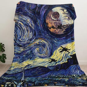 May include: A large, rectangular blanket featuring a vibrant, artistic depiction of a starry night sky with a Death Star and X-wing fighters. The design blends elements of science fiction with a classic painting style, using blues, yellows, and purples.