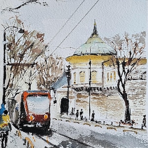 May include: Watercolour painting of a city scene featuring a red and black tram on tracks. A historic building with a green dome and white facade is in the background. Bare trees and figures of people are also visible.