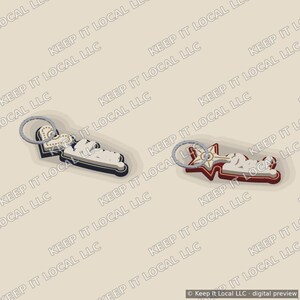 Könnte beinhalten: Zwei Schlüsselanhänger mit silbernen Metallringen. Der linke Schlüsselanhänger hat eine Herzform mit cremefarbener Mitte und dunklem Rand. Der rechte Schlüsselanhänger hat eine Sternform mit cremefarbener Mitte und dunkelrotem Rand.