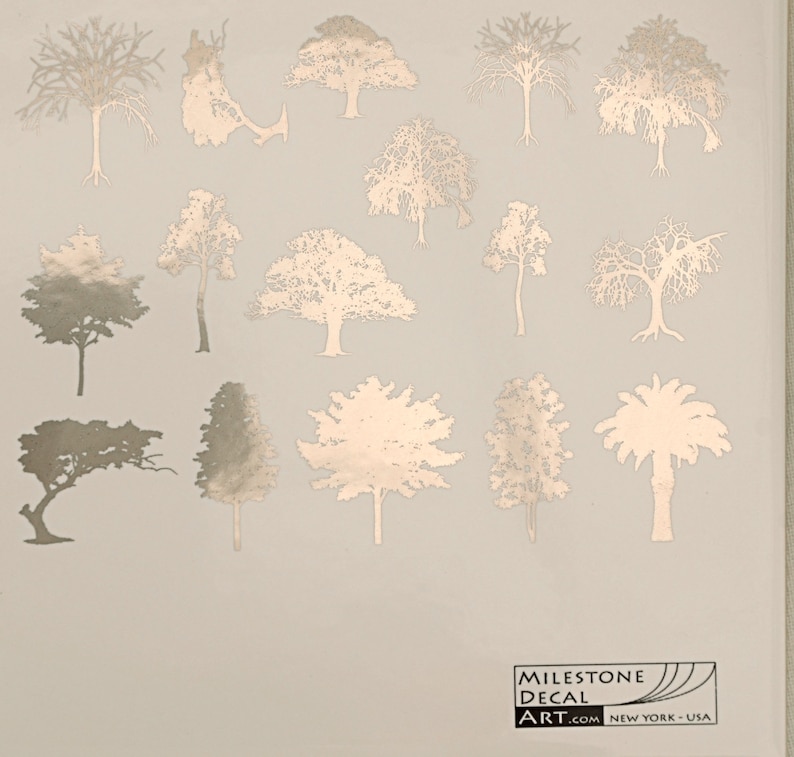 May include: A sheet of gold foil decal stickers featuring various tree silhouettes. The stickers are perfect for adding a touch of nature to any project.