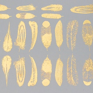 May include: A gray background with 30 gold foil feathers of various shapes and sizes.
