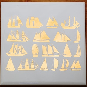 May include: A collection of 18 gold-colored sailboat silhouettes on a light gray background.