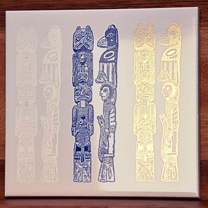 May include: Five stylized totem poles with blue and gold designs. The poles are arranged in a row and are all the same height. The poles are made of wood and have a variety of carvings, including animals, people, and geometric shapes.