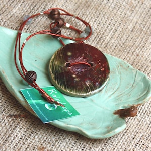 Raku button necklace.  Ceramic copper color button pendant.  Leather cord necklace. Wearable Art . Raku handmade jewelry.