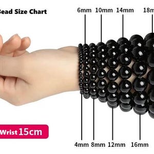 May include: A bead size chart showing various sizes of black beads, from 4mm to 20mm, displayed on a wrist. The text "Various Bead Size Chart" is at the top. The text "Model Wrist 15cm" is at the bottom.