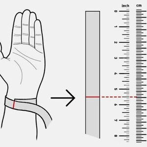 May include: Illustration showing how to measure wrist size for a bracelet. A hand with a measuring tape around the wrist is shown next to a ruler. The measurement is approximately 5.5 inches.