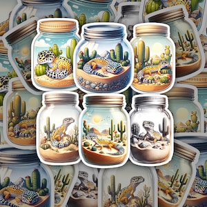 May include: Ten colorful glass jars with cork lids, each containing a desert scene with a gecko lizard. The jars are arranged in a grid pattern on a white background.