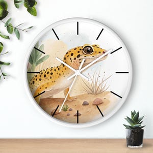 May include: White clock with black hands and a watercolor illustration of a leopard gecko on a desert background.