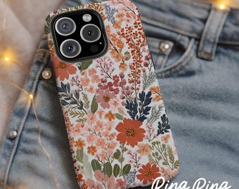 May include: A floral phone case with a white background and a pattern of orange, pink, and blue flowers and green leaves. The case has a camera cutout and the text "Ring Ring CASE CO."