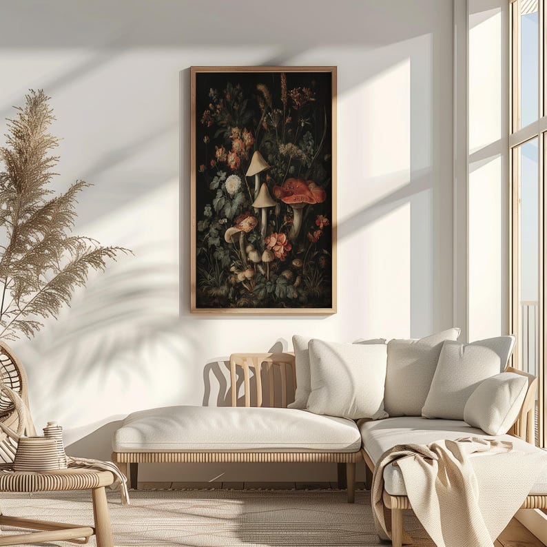 May include: A framed botanical print depicting a dark, atmospheric still life of mushrooms and flowers. The artwork features various fungi with tan and red caps, set amongst lush foliage and blooms. The print is displayed in a light brown wooden frame.