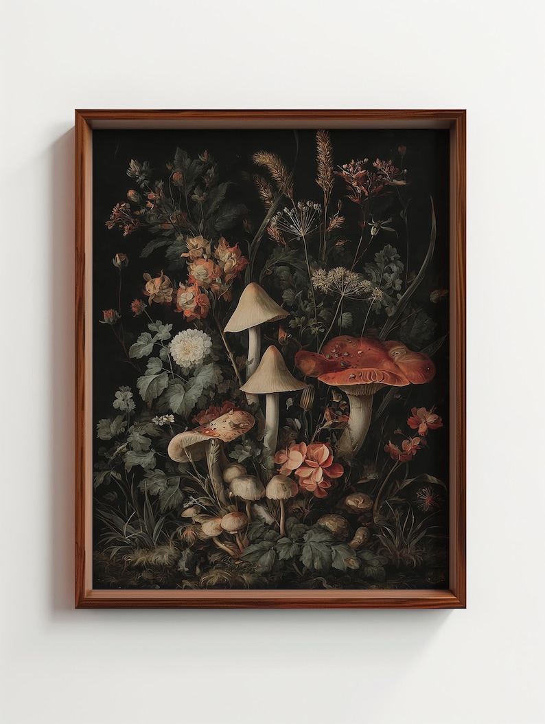 May include: A framed art print depicting a dark botanical scene. The artwork features mushrooms and flowers in shades of red, orange, and cream against a dark backdrop. The frame is a warm brown colour.
