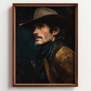 May include: A framed portrait of a man in a cowboy hat and a brown leather jacket. The artwork features a dark, moody color palette with the man's face in focus, showcasing his beard and gaze. The frame is a warm, dark wood.