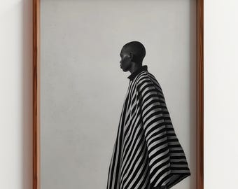 May include: A framed monochrome art print showing a person in profile, wearing a black and white striped garment. The artwork is set against a neutral backdrop, within a wooden frame.