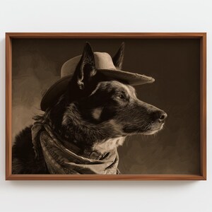 May include: Sepia-toned framed print of a dog wearing a cowboy hat and a patterned scarf. The dog is a medium-sized breed with dark fur and a focused gaze, set against a blurred background.