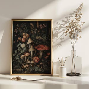 May include: A framed botanical print with a dark backdrop, showcasing mushrooms, flowers, and foliage in red, orange, and green hues. The gold frame enhances the artwork. The print is displayed on a white surface.