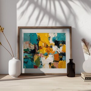 May include: Abstract art print in a wooden frame. The artwork features bold brushstrokes of yellow, teal, white, and orange. A white vase with dried flowers and a black bottle are on a wooden surface.