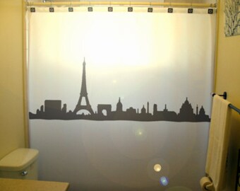 May include: A white shower curtain with a black silhouette of the Paris skyline, including the Eiffel Tower.